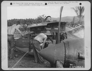 Men Examine A Wrecked Lockheed P-38 Of The 339Th Fighter Squadron, 12Th Fighter Group, Which Crashed On Vella Lavella, Solomon Islands, As A Result Of Enemy Action During A Mission Over Treasury Island On 7 October 1943. A 20 Mm Shell Burst On The Left E (U.S. Air Force Number A67148AC)