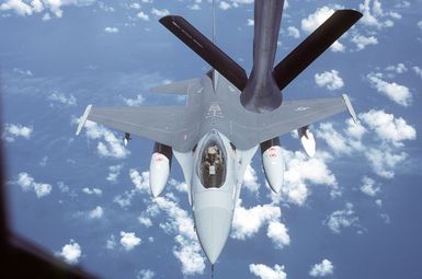 An air-to-air top front view of an F-16 Fighting Falcon aircraft in preparation for refueling, taken from a KC-135 Stratotanker aircraft during a flight from March Air Force Base, Calif., to Hickam Air Force Base, Hawaii