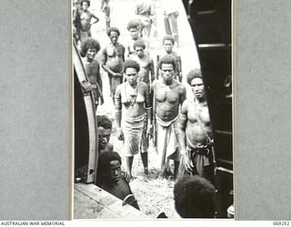 NEW GUINEA NATIVES CLOSELY INSPECTING THE "SWAMP RAT", A DOUGLAS C47 AIRCRAFT, THE FIRST TRANSPORT AIRCRAFT OF THE UNITED STATES 5TH AIR FORCE TO LAND ON THE NEW AIRSTRIP