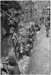 Women with netbags of produce wait for Nancy Cook to give them salt in exchange