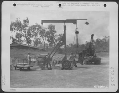 Scales, which were built by the 27th Air Depot Group for weighing heavy equipment, are in balance. Port Moresby Air Depot, Papua, New Guinea. 1943. (U.S. Air Force Number 67696AC)