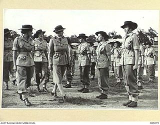 ENOGGERA, QUEENSLAND. 1945-04-26. THE CONTROLLER OF AUSTRALIAN WOMEN'S ARMY SERVICE COLONEL S.H. IRVING, (4), INSPECTING NO. 5 PLATOON, OF 68 AUSTRALIAN WOMEN'S ARMY SERVICE BARRACK, WHO ARE ON ..
