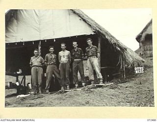 DUMPU, NEW GUINEA. 1944-04-19. KITCHEN STAFF AT THE OFFICERS' MESS, HEADQUARTERS 15TH INFANTRY BRIGADE. IDENTIFIED PERSONNEL ARE:- V325420 PRIVATE T.L. KLEMKE (1); VX111803 SERGEANT K.G. BAINES ..