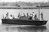 Guam, military officers on boat sailing along waterfront