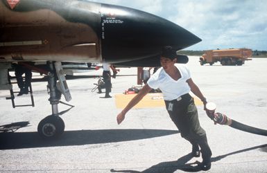 A ground crewman prepares to refuel a Hawaii Air National Guard F-4C Phantom II aircraft