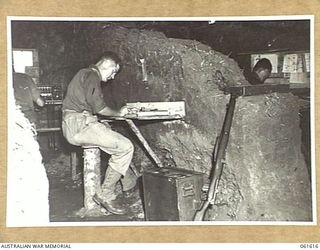 DUMPU, RAMU VALLEY, NEW GUINEA. 1943-11-29. WIRELESS CONTROL ROOM, A SECTION, HEADQUARTERS, 7TH AUSTRALIAN DIVISION. SHOWN ARE: NX5680 LIEUTENANT L. T. PHILLIPS, SECOND IN CHARGE, A SECTION (1); ..