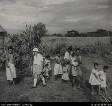 Field Officer with farmer and his family