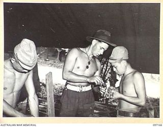 A JAPANESE CARPENTER AND ELECTRICIAN WORKING UNDER THE GUIDANCE OF SIGNALMAN L.V. FRISBY, DOING CONSTRUCTIVE WORK AT 11 DIVISION SIGNALS