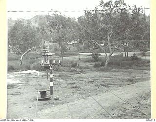 PORT MORESBY, NEW GUINEA. 1944-02-07. AN ELECTRIC MESSAGE CONVEYOR VIEWED FROM THE 18TH LINES OF COMMUNICATION SIGNALS OFFICE ON ITS JOURNEY TO THE HEADQUARTERS, NEW GUINEA FORCE MESSAGE CENTRE, A ..