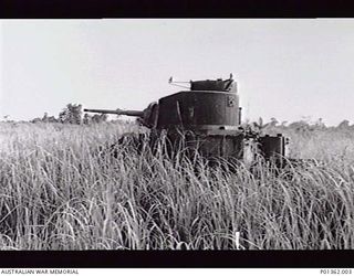 BUNA, PAPUA. 1952. AN AMERICAN GENERAL STUART M3 LIGHT TANK ABANDONED AMONGST THE KUNAI GRASS. IN 1942-12 THIS WAS MANNED BY 2/6TH ARMOURED REGIMENT IN SUPPORT OF 2/10TH BATTALION TROOPS ATTACKING ..