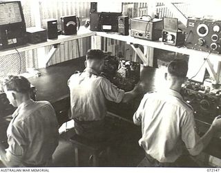 PORT MORESBY, NEW GUINEA. 1944-04-10. THE SCREEN ROOM AT THE 11TH ADVANCED WORKSHOP, AUSTRALIAN ELECTRICAL AND MECHANICAL ENGINEERS. THE ROOM IS USED FOR THE FINAL TESTING OF WIRELESS SETS