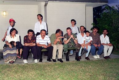 Captain John Keane, SENIOR Arabic Linguistic, Combat Service Support Detachment 37, in support of Operation PACIFIC HAVEN, holds a conversation with Kurdish evacuees during their festivities of Eid-af-altar. This is a Muslim tradition that celebrates the end of Ramadan, a month of fasting and gaining spiritual enlightenment. PACIFIC HAVEN provided Kurdish evacuees political asylum from Iraq. While on Guam, the Kurds are provided shelter, food, clothing, medical care and assimilation classes for life in the United States