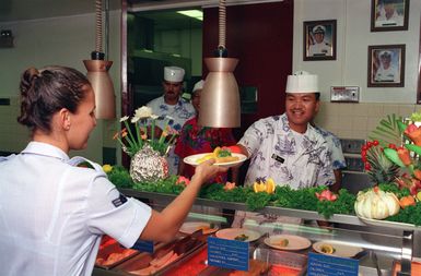 A mess management specialist serves breakfast in the enlisted galley prior to the arrival of President William Jefferson Clinton. The president is in Hawaii on a tour of area military installations