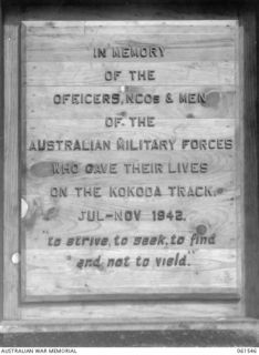 PORT MORESBY, NEW GUINEA. 1943-12-14. PRELIMINARY WOOD MOULD OF A PLAQUE WHICH IS TO BE MOUNTED ON THE MAIN KOKODA TRAIL, PHOTOGRAPHED AT THE DEPUTY ASSISTANT DIRECTOR OF EDUCATION HEADQUARTERS. ..