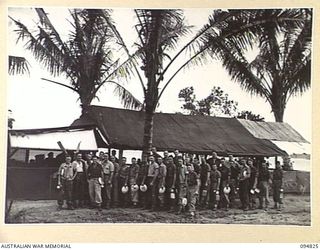 TOL, NEW BRITAIN, 1945-08-04. PERSONNEL OF 52 TRANSPORT PLATOON LINED UP FOR MESS AT THEIR KITCHEN NEAR THE BEACH AT TOL