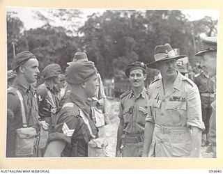 HONGORAI RIVER, BOUGAINVILLE, 1945-07-04. HIS ROYAL HIGHNESS, THE DUKE OF GLOUCESTER, GOVERNOR-GENERAL OF AUSTRALIA (4), SPEAKING TO TROOPS OF HEADQUARTERS 3 DIVISION DURING HIS VISIT TO FORWARD ..
