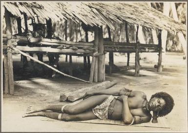 Mailu Island types [man in sleeping position on ground] / Frank Hurley