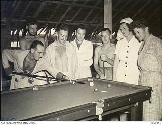 MADANG, NEW GUINEA. C. 1945. AMUSEMENTS ARE PROVIDED IN THE CONVALESCENT WARD FOR PATIENTS RECOVERING FROM ILLNESSES AND HERE 500147 SENIOR SISTER E. DOHERTY OF NO. 1 MEDICAL RECEIVING STATION ..