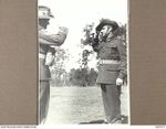 STRATHPINE, QLD. 1944-07-20. QX11325 LANCE-SERGEANT J.M. BALL (1) OF THE 2/25TH INFANTRY BATTALION, SALUTE QX6305 MAJOR T.J.C. O'BRYEN, ADMINISTRATION COMMANDER (2) AFTER RECEIVING THE BRITISH ..