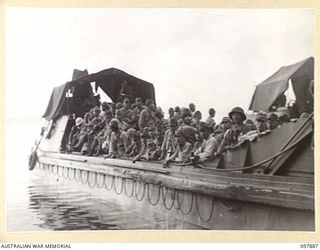 KAHILI, BOUGAINVILLE. 1945-09-30. A LANDING BARGE OF 42 LANDING CRAFT COMPANY, PACKED WITH JAPANESE ARMY TROOPS FROM THE BUIN AREA WHO ARE BEING TRANSFERRED TO FAURO ISLAND. THEIR TRANSPORTATION ..