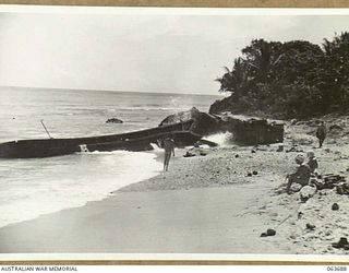 HUON PENINSULA, NEW GUINEA. 1944-01-14. TWO OF THE MANY WRECKED JAPANESE BARGES ALONG THE COAST. A NUMBER WERE WRECKED BY THE ROUGH SEAS BUT MANY MORE WERE DAMAGED AND SUNK BY AMERICAN PT BOATS