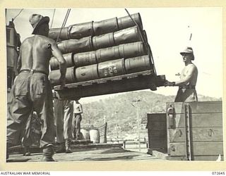 PORT MORESBY, NEW GUINEA. 1944-04-26. THE UNLOADING OF SUPPLIES FROM HMT MONTORO DIRECTLY TO TRUCKS ALONGSIDE PORT MORESBY WHARF FOR TRANSPORTATION TO NO.5 BASE SUPPLY DEPOT. THE DOCKS ARE OPERATED ..