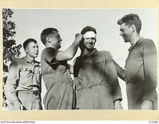 1943-08-03. THESE MEN, SOME SURVIVORS OF A CREW OF SIX OF A MITCHELL BOMBER WHICH CRASHED NEAR SALAMAUA, WERE 10 1/2 HOURS IN THE WATER BEFORE THEY REACHED LAND. LEFT TO RIGHT: SGT. WALTER MALONE, ..