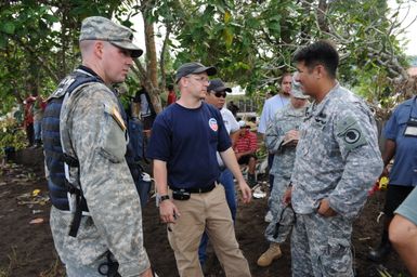 Earthquake ^ Tsunami - Leone, American Samoa, October 2, 2009 -- Chris Reiner, U. S. Environmental Protection Agency (EPA), discusses hazardous waste removal with members of the Hawaii National Guard, Civil Support Team. The EPA and U. S. military are part of the federal family that support the Federal Emergency Management Agency in its recovery from the recent earthquake and tsunami.