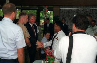 President William Jefferson Clinton greets enlisted personnel of the various services as he arrives for breakfast at the enlisted galley during a tour of area military installations
