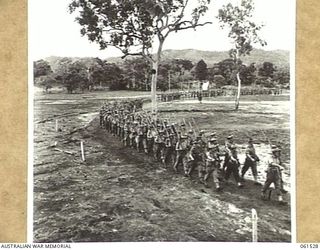 POM POM VALLEY, NEW GUINEA. 1943-11-30. 2/12TH AUSTRALIAN INFANTRY BATTALION, MARCHING OFF THE SHOWGROUND AFTER AN INSPECTION BY THEIR COMMANDING OFFICER QX6008 LIEUTENANT COLONEL C. C. F. BOURNE. ..