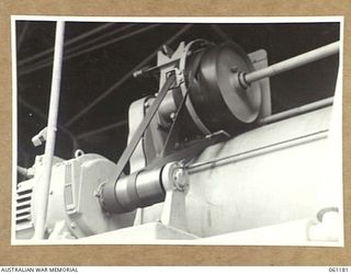 17 MILE, PORT MORESBY AREA, NEW GUINEA. 1943-12-04. ELECTRIC MOTOR DRIVING A WASHING MACHINE AT THE 9TH AUSTRALIAN DIVISION MOBILE LAUNDRY