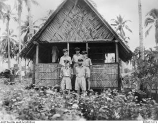 LUNGGA, GUADALCANAL, SOLOMON ISLANDS, 1944-02-29. THE DEPUTY SUPERVISING INTELLIGENCE OFFICER (DSIO), NAVAL INTELLIGENCE DIVISION, RAN, AND HIS OFFICER STAFF IN FRONT OF THE DSIO'S CABIN AT HIS ..