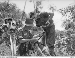KOKODA TRAIL, NEW GUINEA. 1943-12-19. MR GEORGE HEATH, CHIEF CAMERAMAN FOR CHAUVEL'S PRODUCTIONS (1) AND VX117252 CAPTAIN G. H. NICHOLSON, OFFICER COMMANDING, MILITARY HISTORY SECTION, ATTACHED ..