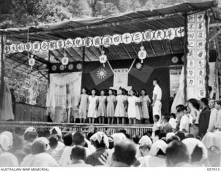 RABAUL, NEW BRITAIN. 1945-10-10. A SPECIAL PARADE AND CONCERT WAS HELD AT THE CAMP TO CELEBRATE THE 34TH ANNIVERSARY OF THE FOUNDING OF THE CHINESE REPUBLIC. SHOWN, CHINESE GIRLS' CHOIR ON STAGE AT ..