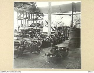 LAE, NEW GUINEA. 1944-09-27. THE MOTOR SPARE PART SECTION OF THE 43RD FIELD ORDNANCE DEPOT SHOWING DIFFERENTIAL HOUSINGS, SPRINGS, WHEELS AND GEAR BOXES