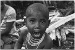 Pig festival, pig sacrifice, Tsembaga: child with shell bead necklace and ear piercing at ancestral shrine