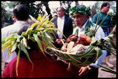 Woman carrying basket of food, Rarotonga