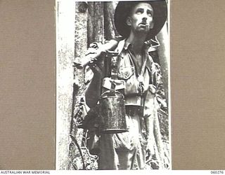 GUY'S POST, FARIA RIVER AREA, NEW GUINEA. 1943-11-08. NX23154 PRIVATE E. WHITE OF KINGS CROSS, NSW, AND OF THE 2/33RD AUSTRALIAN INFANTRY BATTALION MOVING TO GUY'S POST TO RELIEVE MEMBERS OF THE ..