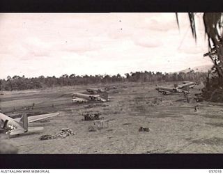 NADZAB AIRSTRIP, NEW GUINEA. 1943-09-18. PHOTOGRAPH TAKEN FROM THE CONTROL TOWER SHOWING TRANSPORT AIRCRAFT IN THEIR DISPERSAL AREAS