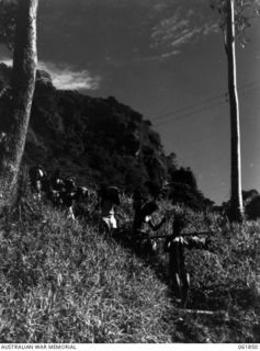 UBERI, NEW GUINEA. 1943-12-19. NATIVE CARRIERS TAKING SUPPLIES TO THE "FRONT LINE" ON THE KOKODA TRAIL IN THE OWEN STANLEY RANGES DURING THE FILMING OF THE PRODUCTION "RATS OF TOBRUK" BY CHAUVEL'S ..