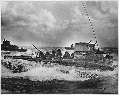 A Water Buffalo, loaded with Marines, churns through the sea bound for beaches of Tinian Island near Guam.