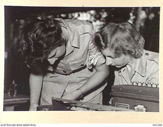 LAE, NEW GUINEA, 1945-05-23. AUSTRALIAN WOMEN'S ARMY SERVICE PERSONNEL AT NUMBER 1 SUB DEPOT, 4 ADVANCED ORDNANCE DEPOT, PREPARING VOUCHERS ON THE ELLIOTT FISHER MACHINE. AUSTRALIAN WOMEN'S ARMY ..