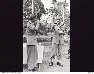 LAE, NEW GUINEA, 1945-12-07. CAPTAIN L. D. CRANE, ASSISTANT CONTROLLER AUSTRALIAN WOMEN'S ARMY SERVICE, AND BRIGADIER P. S. MCGRATH, DEPUTY DIRECTOR OF SUPPLY AND TRANSPORT, FIRST ARMY, ENJOYING ..