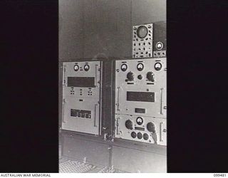 JACQUINOT BAY, NEW BRITAIN, 1945-11-20. THE MAIN CONTROL PANEL OF THE AUSTRALIAN ARMY AMENITIES SERVICE BROADCASTING STATION 9AE