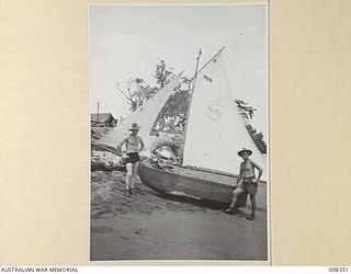 WEWAK, NEW GUINEA. 1945-10-28. STAFF SERGEANT W. PITHIE (1) AND CORPORAL BRASNETT (2) MEMBERS OF 16 INFANTRY BRIGADE, ALONGSIDE FLYING PO, THEIR ENTRY IN THE WEWAK REGATTA TO BE HELD IN DALLMAN ..