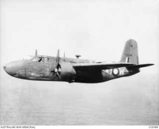 NEAR KIRIWINA, TROBRIAND ISLANDS, PAPUA. C. 1943-12. LOW OVER THE WATER, A BOSTON BOMBER AIRCRAFT, CODED DU-W, RAAF SERIAL NO. A28-30, OF NO. 22 SQUADRON RAAF FLIES TO ITS TARGET IN NEW BRITAIN