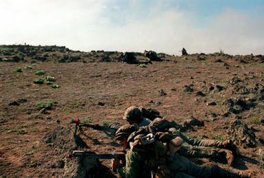 Members of the 2nd Battalion, 25th Infantry Division, conduct a fire fight against opposing forces during Opportune Journey 4-83