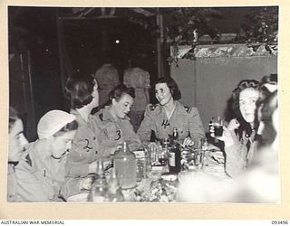 TOROKINA, BOUGAINVILLE. 1945-07-02. A GROUP OF AUSTRALIAN ARMY NURSING SERVICE SISTERS IN THE SISTERS' MESS, 2/1 GENERAL HOSPITAL DURING A FORMAL DINNER CELEBRATING THE 43RD ANNIVERSARY OF THE ..
