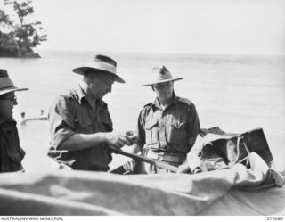 NEW GUINEA. 1944-01-24. NX112720 MAJOR E.W. GREGORY, BRIGADE MAJOR HEADQUARTERS 8TH BRIGADE, PICTURED IN A LANDING CRAFT MECHANIZED WITH THE 8TH BRIGADE COMMANDER NX110380 BRIGADIER C.E. CAMERON