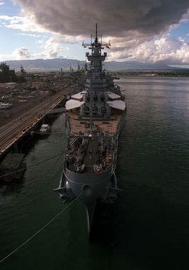 The battleship USS NEW JERSEY (BB-62) lies tied up at the naval station during a visit.
